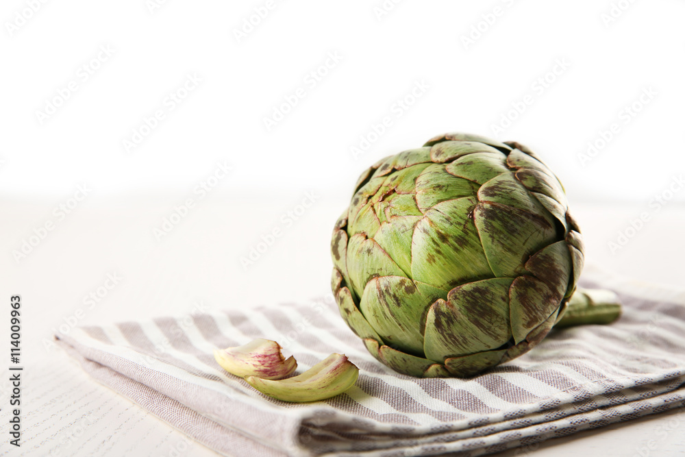 Raw artichoke on napkin