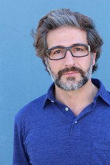 Closeup portrait of happy handsome mature man with glasses