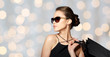 happy woman in black sunglasses with shopping bags