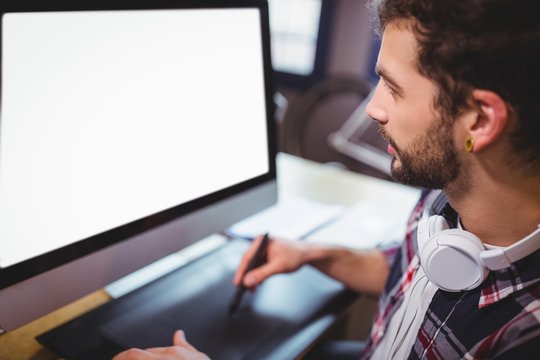 Graphic designer looking at computer monitor while working