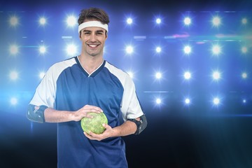 Wall Mural - Composite image of sportsman posing with ball