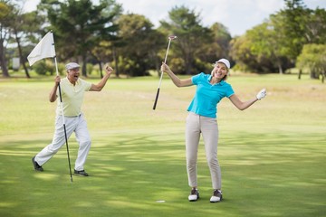 Golfer couple celebrating success