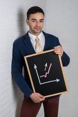 Man in a suit with a black board in his hands on a white backgro