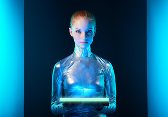 Futuristic young woman in silver clothing