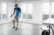 © puhhha - Sport Fitness Workout. Healthy Man Skipping Jump Rope Indoors.