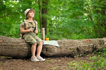 girl looking birds through binoculars, camping in the woods