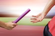 © vectorfusionart - Composite image of athlete passing a baton to the partner