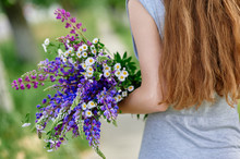 Woman Holding A Bouquet Of Blue Lupine Flowers