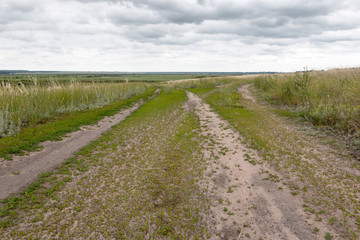 fork in the road field road on a hill