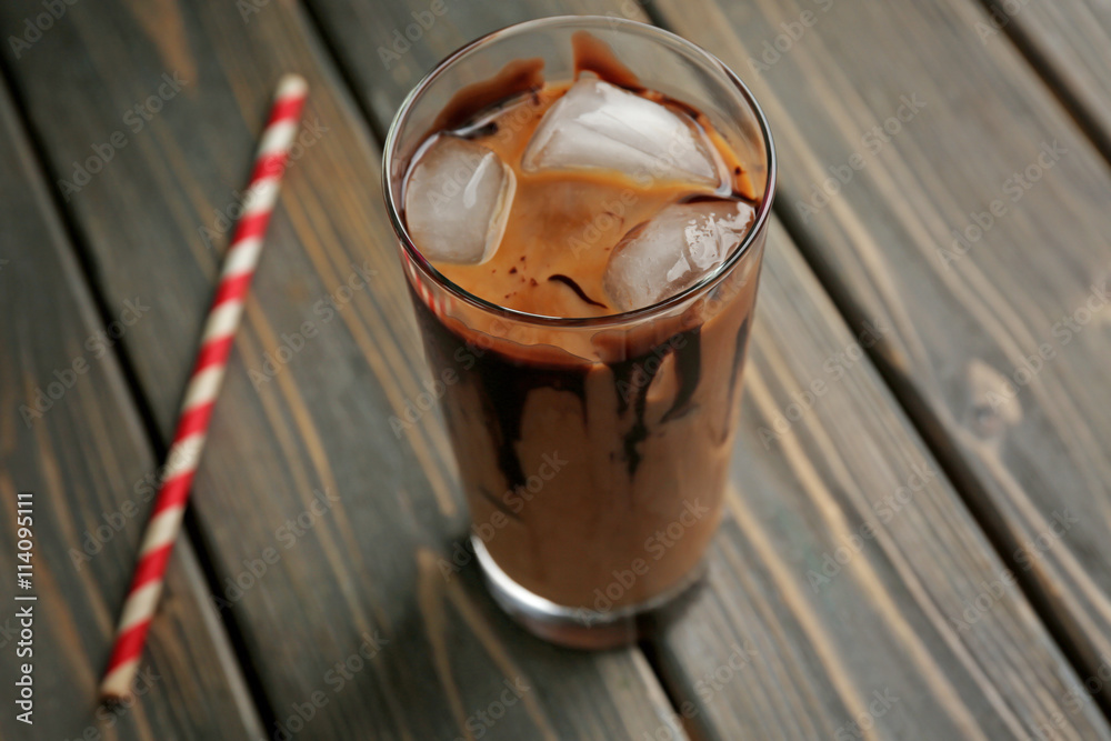 Glass of iced coffee on wooden table