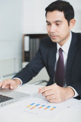 Wall Mural - Handsome Asian businessman working in the office with laptop com