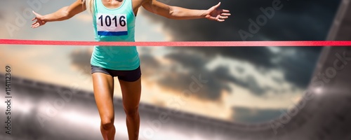 Fotografía Composite image of sportswoman finishing her run