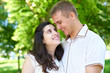 © soleg - pregnant woman with husband posing in the city park, family portrait, summer season, green grass and trees