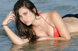 Beautiful model wear bikini lying in sea