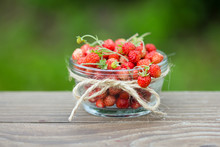 Ripe Berries Of Wild Strawberries In Glass Bowl. On Wood Background, Closeup.