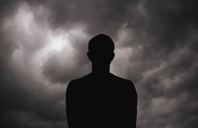 Young Man  Standing Around The Dramatic Sky Before Storm