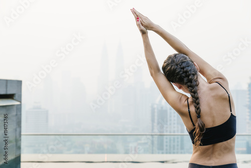 Fotografia, Obraz Relaxed young yoga woman in yoga pose near pool.