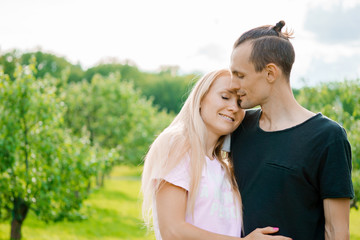 Wall Mural - Couple standing in park and hugging