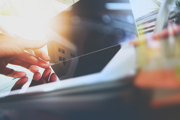 Poster - close up of Designer hand working with laptop computer on wooden