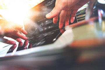 Poster - close up of Designer hand working with laptop computer on wooden