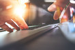 © everythingpossible - close up of Designer hand working with laptop computer on wooden