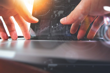 close up of business man hand working on laptop computer with di