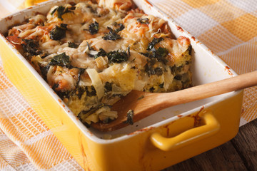 casserole with spinach, cheese and bread close up in baking dish. horizontal
