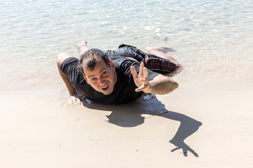 Wall Mural - wrecked man on the coastline stretches out his hand for help