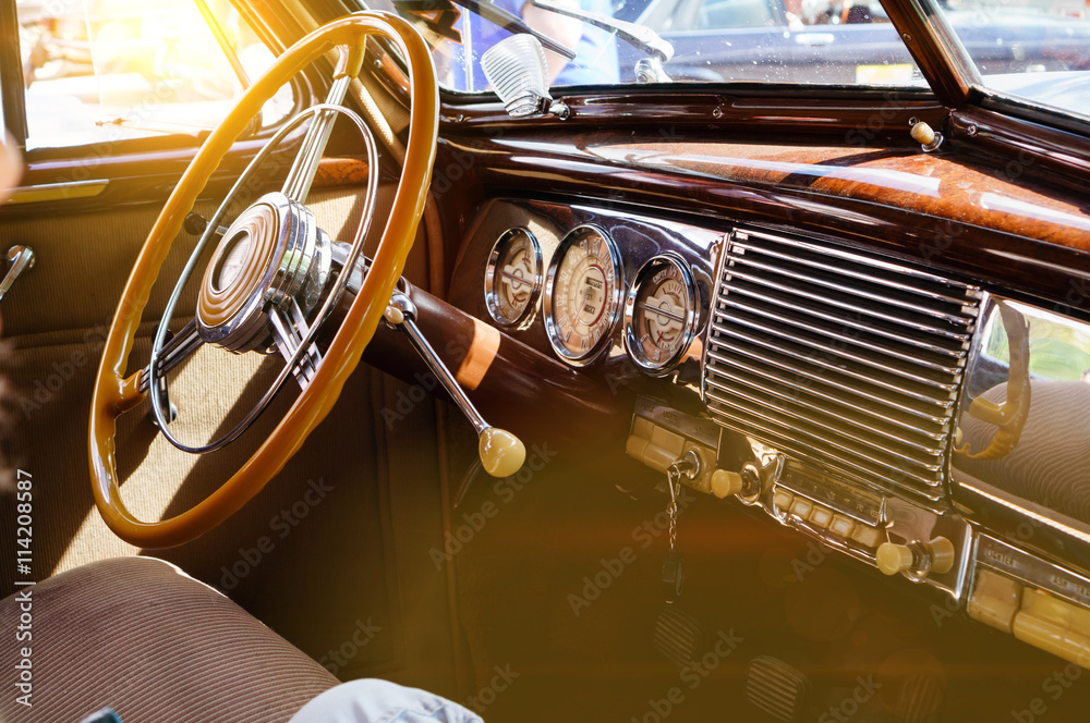 Interior of a classic vintage car with sun glare - obrazy, fototapety, plakaty 