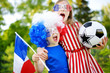 © MNStudio - Two funny little sisters supporting and cheering their national football team