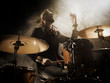 © Voloshyn Roman - Silhouette drummer on stage. Dark background, smoke spotlights