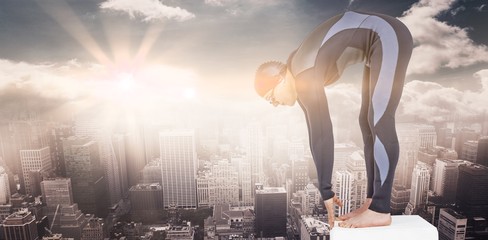 Poster - Composite image of swimmer in wetsuit preparing to dive