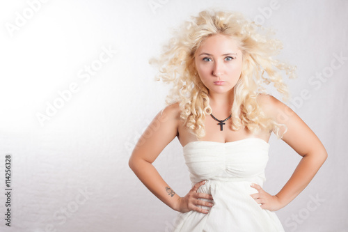 Handsome Young Woman In White Dress With Curly Hair Looking