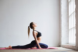 Beautiful woman doing stretching exercises in the gym.