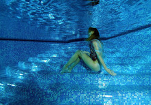 Woman Presenting Underwater Fashion In A Pool