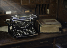 Vintage Typewriter In Old Office With Sunbeams And Books