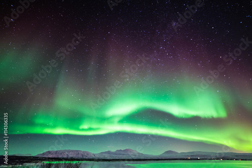 An aurora, sometimes referred to as a polar light, is a natural light display in the sky, predominantly seen in the high latitude (Arctic and Antarctic) regions Poster