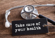© Lemau Studio - Take care of your health words written on label tag with Stethoscope on wood as medical concept