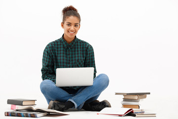 Portrait of young african girl with laptop over white background