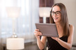 Woman smiling and holding tablet