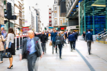 Wall Mural - Business people walk through the City of London street. Blurred image. City of London business life concept 