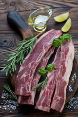 Wall Mural - Raw fresh seasoned beef ribs in a rustic wooden setting