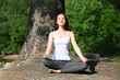 © Africa Studio - Young girl in lotus position on beach