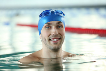 Wall Mural - Handsome sporty man in the swimming pool