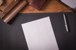 © pelinoleg - with paper with pen o a leather table