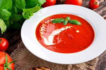 Wall Mural - Smooth and sweet tomato soup, seasoned with basil, garlic.