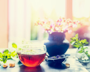 Wall Mural - Summer herbal tea with fresh herbs on window sill. Healthy ,healing or detox drinks concept