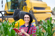 Farmer girl on field with combine harvester
