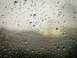 Fototapeta Tęcza - Selective focus, Raindrops on glass with city (raindrops,blur, rain)