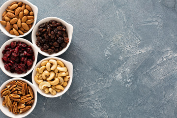 Wall Mural - Variety of nuts and dried fruits in small bowls